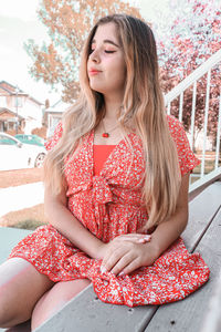 Beautiful young woman sitting in traditional clothing