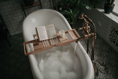 Luxury interior of big bathroom at modern african style with oval bathtub in natural lighting