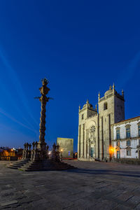 Illuminated building against blue sky