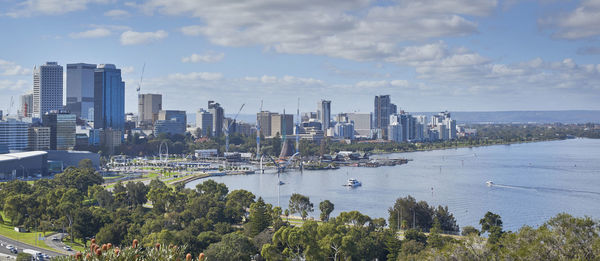 Panoramic view of sea and cityscape against sky