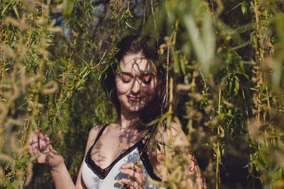 Young woman amidst plants