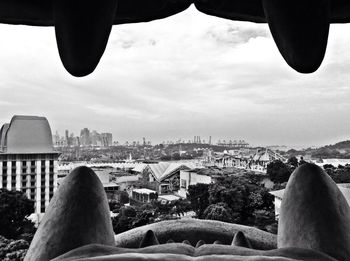Cityscape against cloudy sky