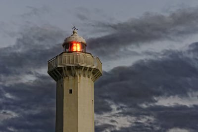 Low angle view of lighthouse against cloudy sky