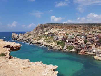 Panoramic view of sea and buildings against sky