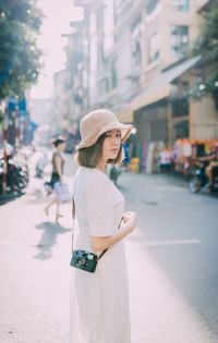 Woman standing on street in city