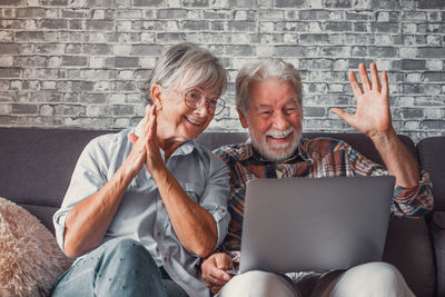 Young woman using laptop while sitting at home