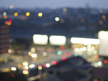 Defocused image of illuminated city at night