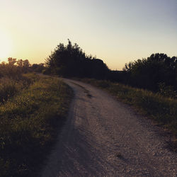 Empty road against clear sky during sunset