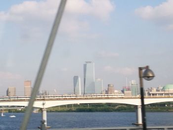 View of suspension bridge with city in background