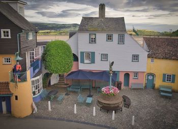 Potted plants on table by building against the sky at portmeirion, wales.