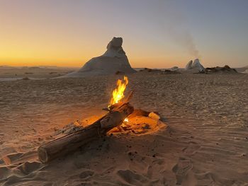 Scenic view of beach against sky during sunset