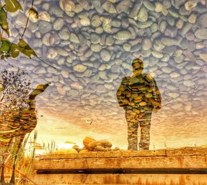 Full length of man standing by stone wall