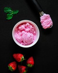 High angle view of pink fruits in container