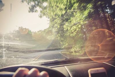 Close-up of person seen through car windshield