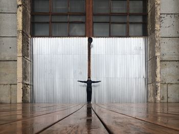 Rear view of man standing in building