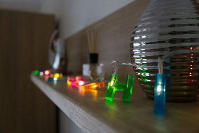 Close-up of illuminated lighting equipment on table at home