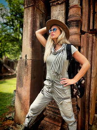 Portrait of woman standing against tree