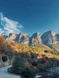 Scenic view of mountains against blue sky