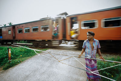 Man walking against train