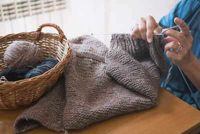 Cropped hand knitting wool on table