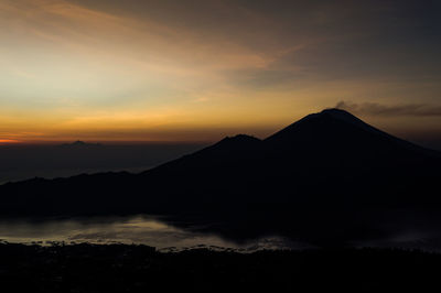 Scenic view of silhouette mountains against sky during sunset