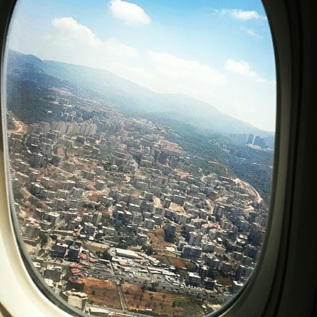 AERIAL VIEW OF CITYSCAPE FROM AIRPLANE WINDOW