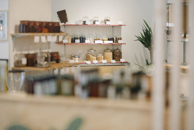 Interior of cafe with glass jars arranged on shelf