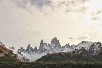 Scenic view of mountains against cloudy sky