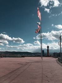 Flag on pole against sky