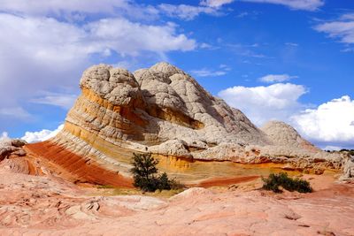 View of rock formation against cloudy sky