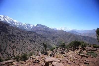 Scenic view of mountains against clear blue sky