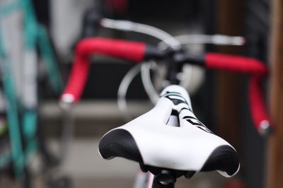 Close-up of bicycle hanging on motorcycle