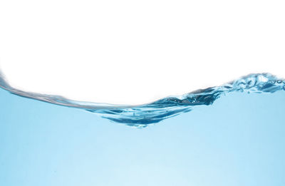 Surface level of water against white background