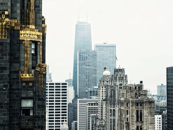 Modern buildings in city against clear sky