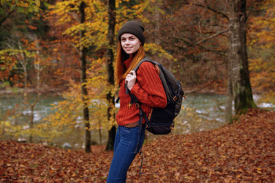 Portrait of smiling man in forest during autumn