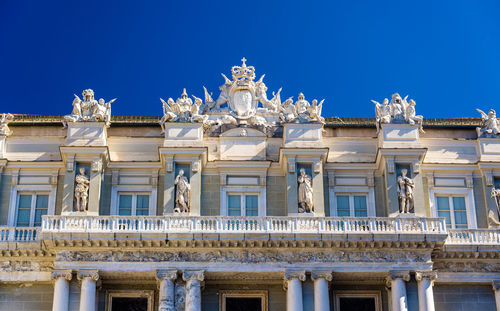 Low angle view of historical building against blue sky