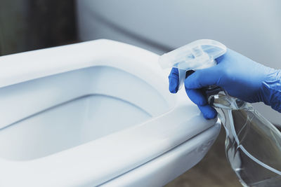 Cropped hand washing hands in bathroom