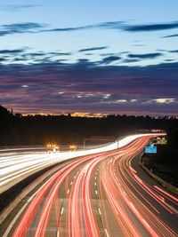 High angle view of light trails on highway at night