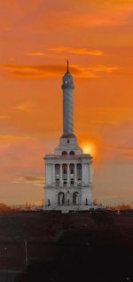 Low angle view of tower against sky during sunset