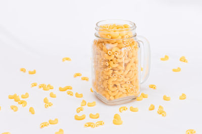 Close-up of food in jar against white background