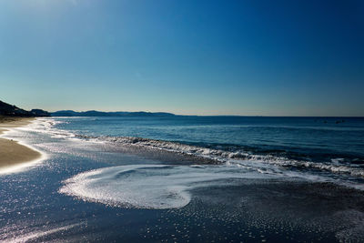 Scenic view of sea against clear blue sky