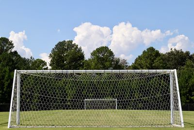 View of soccer field against cloudy sky