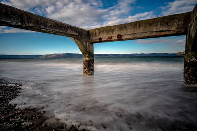 Bridge over sea against sky