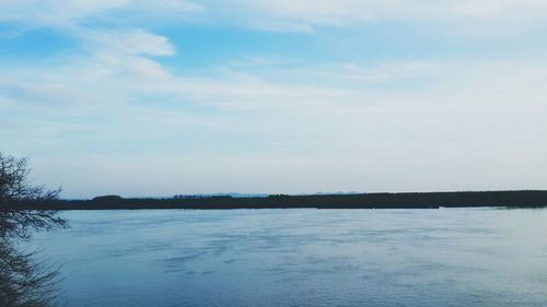 Scenic view of lake against sky during winter