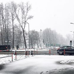 Snow covered road against sky in winter