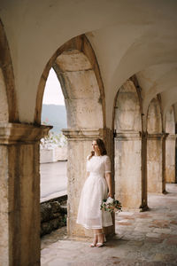 Full length of bride standing in corridor