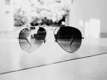 Close-up of sunglasses with reflection on mirror