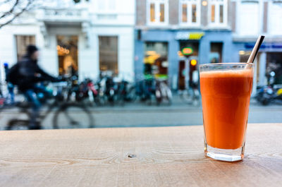 Close-up of drink on table by street