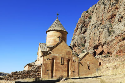 Low angle view of historic building against clear blue sky