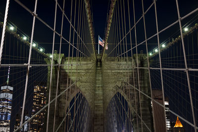 Low angle view of illuminated footbridge at night